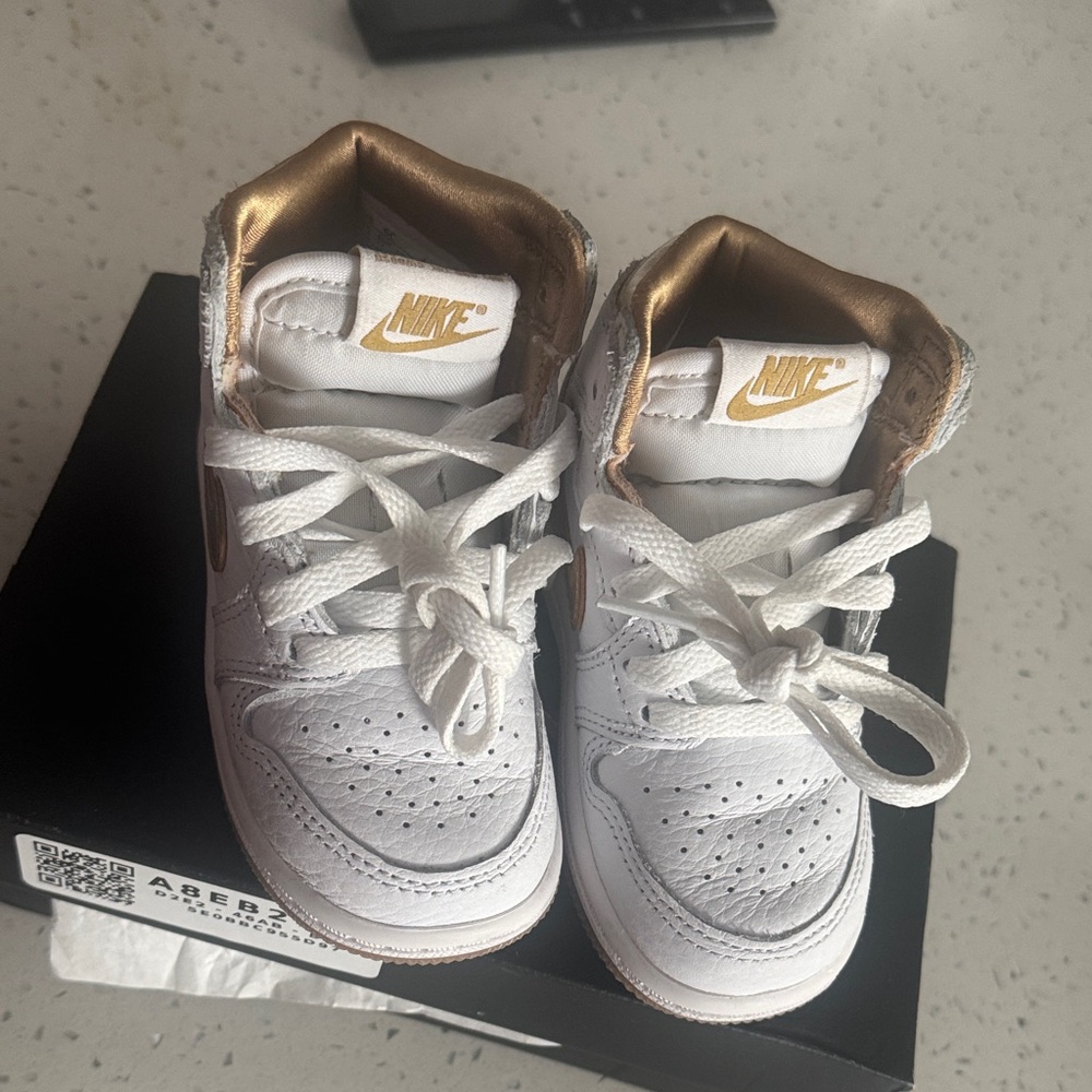 Nike Kids White Sneakers with Gold Highlights
